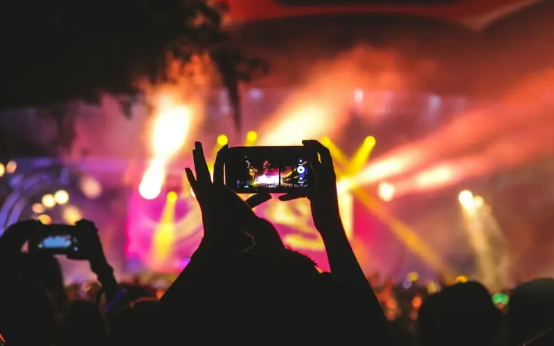Concert crowd filming the stage