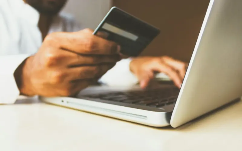 Paying online with a card on a laptop